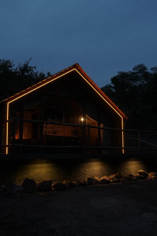 a building lit up at night with lights on it at Recanto dos Licuris in Lençóis