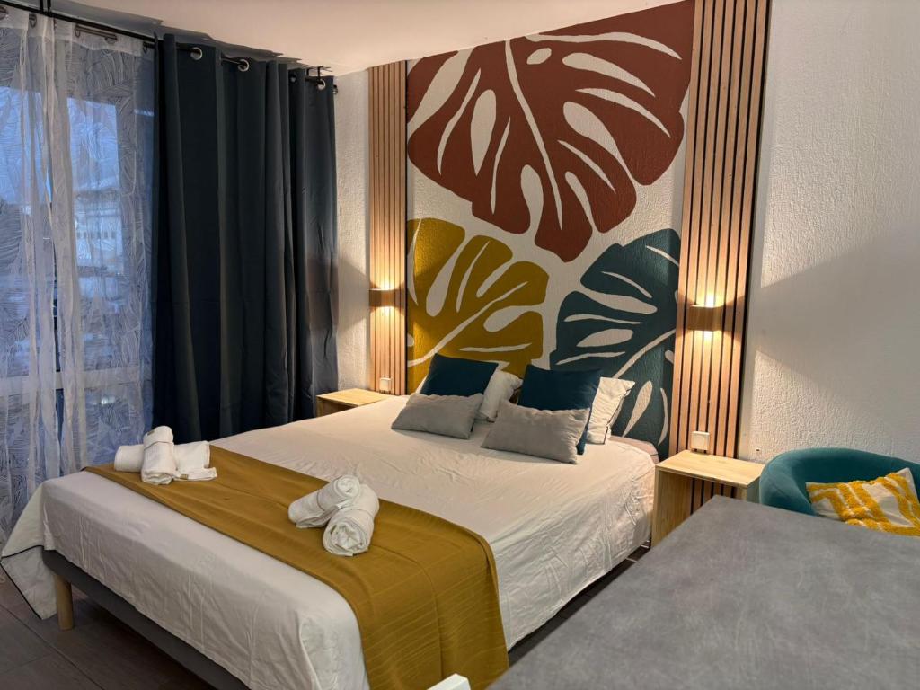 a hotel room with two beds with towels on them at Studio en bord de mer - létama - Résidence Archipel Savane in Le Gosier