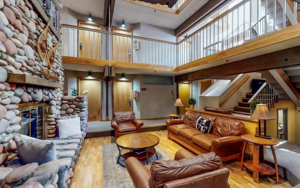 a large living room with a large stone wall at 3 bdrm cottage in Predeal in Predeluţ