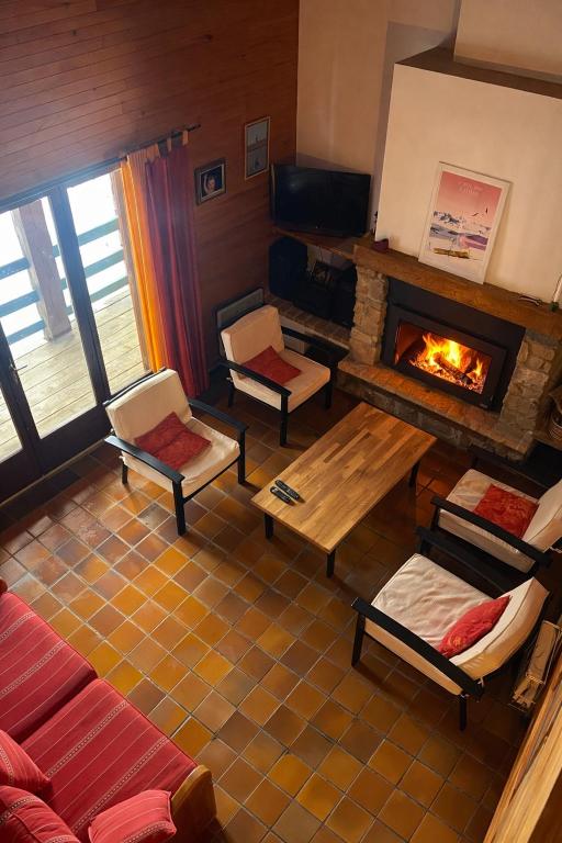 a living room with a couch and a fireplace at The chalet of time in Eyne