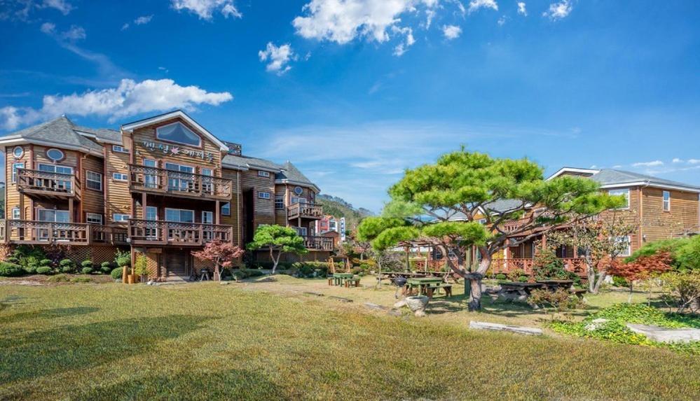 a large house with a yard in front of it at Buan Pension Maple in Buan