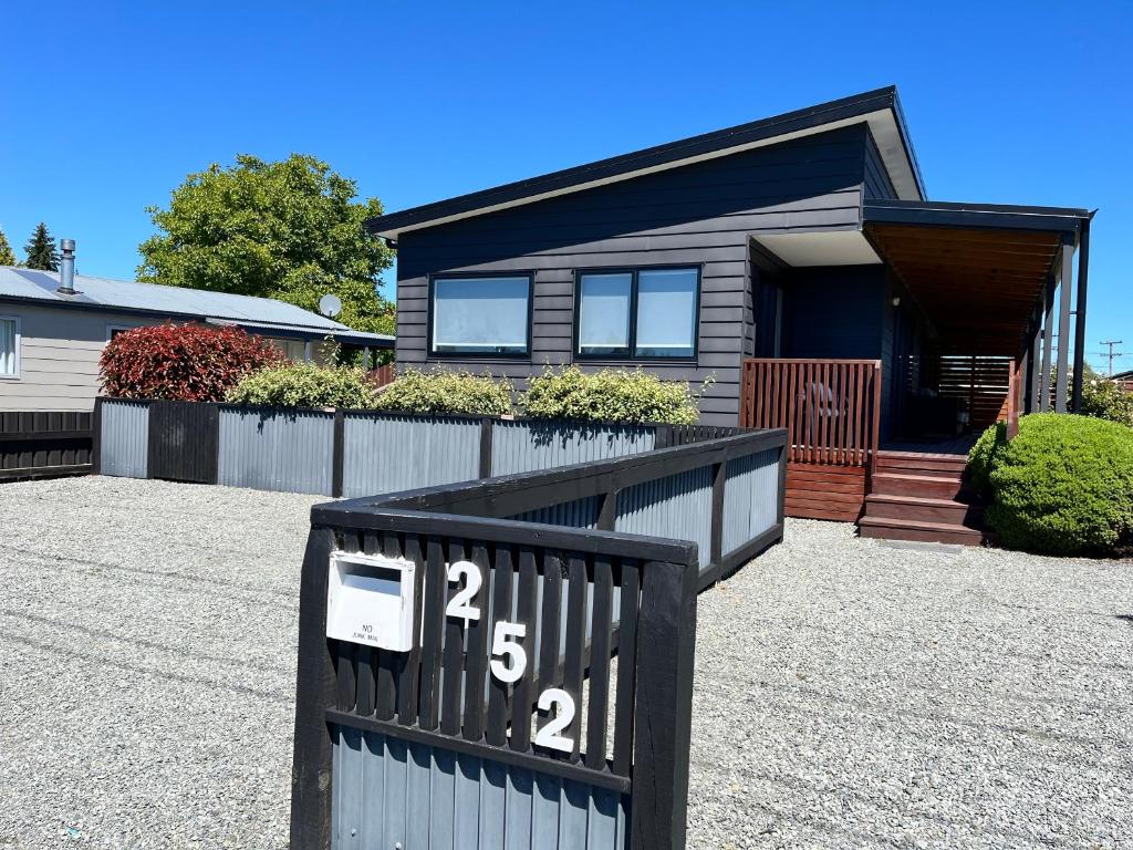 a house with a sign in front of it at Mountain views on Mackenzie in Twizel