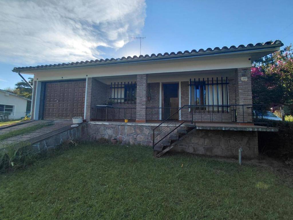 a small brick house with a porch and stairs at Vallesito in Salsipuedes