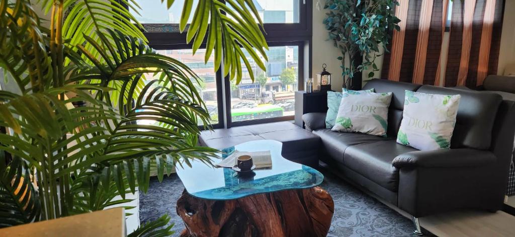 a living room with a couch and a table at La Casa Verde in Seoul