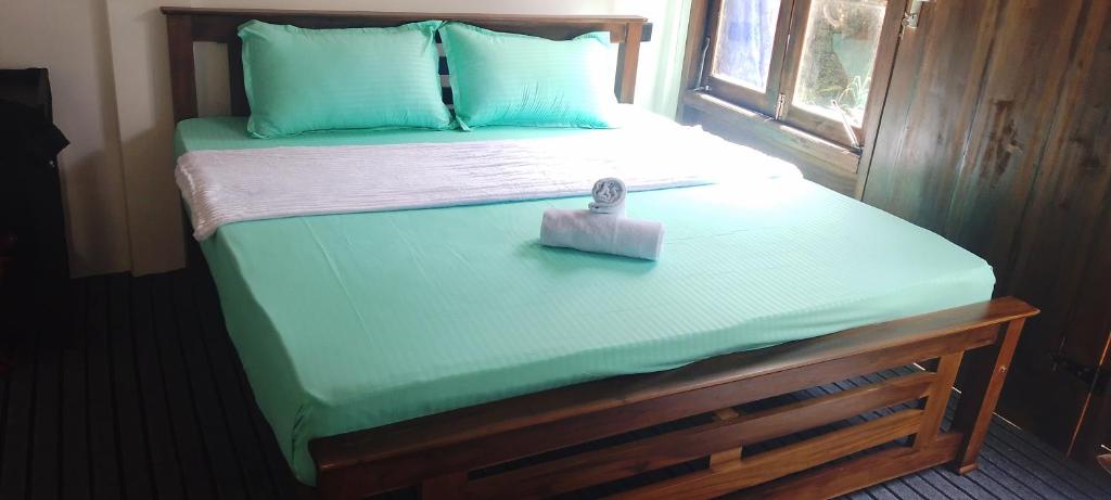 a bed with a small box on top of it at Pavis guest inn in Nallathanniya