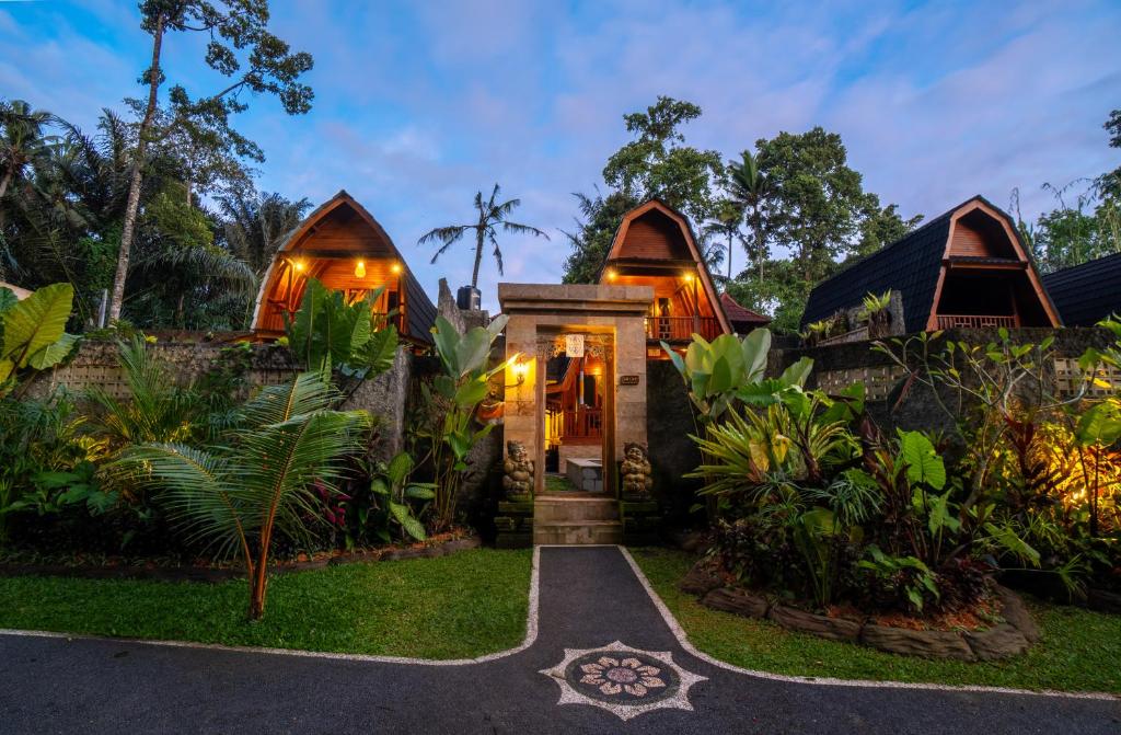 a home with a pathway leading to the front door at Jungle Forest Villa Ubud by The Travel Ubud Bali in Ubud