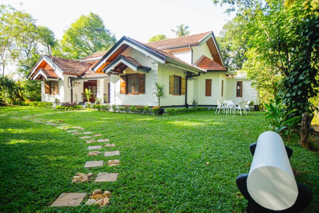 a house with a yard with a pathway at Cinnamon Legacy in Weligama