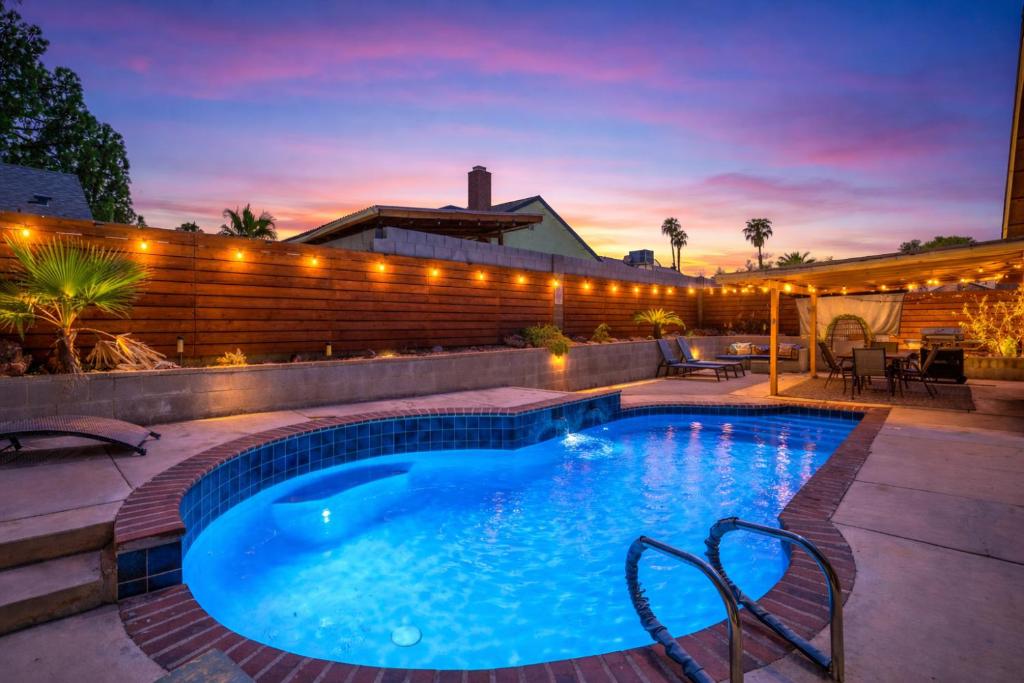a swimming pool in a backyard at night at ᨒོ The Good Life - Fun Pool Escape 15 min to Strip in Las Vegas