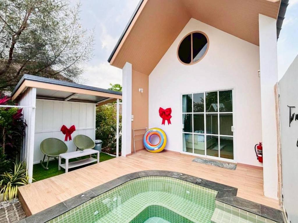a house with a swimming pool in front of it at Rabbit Villa Bangsaray in Bang Sare