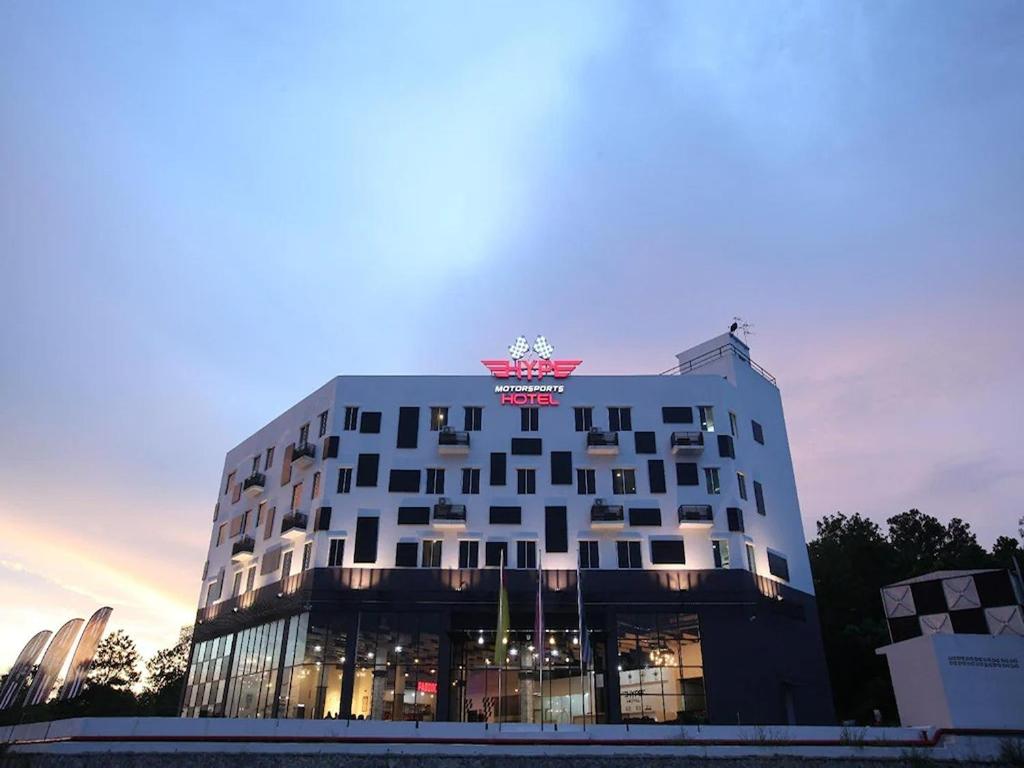 a building with a clock on the top of it at Arafah Hotel Nilai in Kampong Tanjong