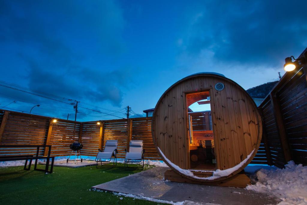 a round wooden cabin with chairs and a table at 禅ーZen Villa Hakodate in Hakodate