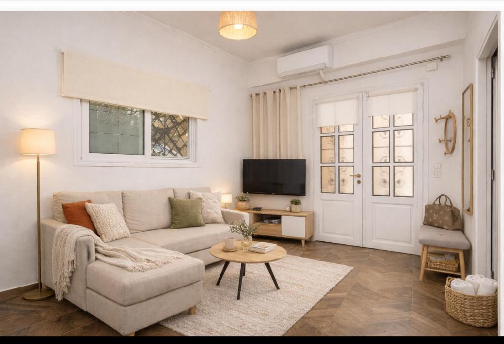 a living room with a couch and a table at villa Chris in Pylos