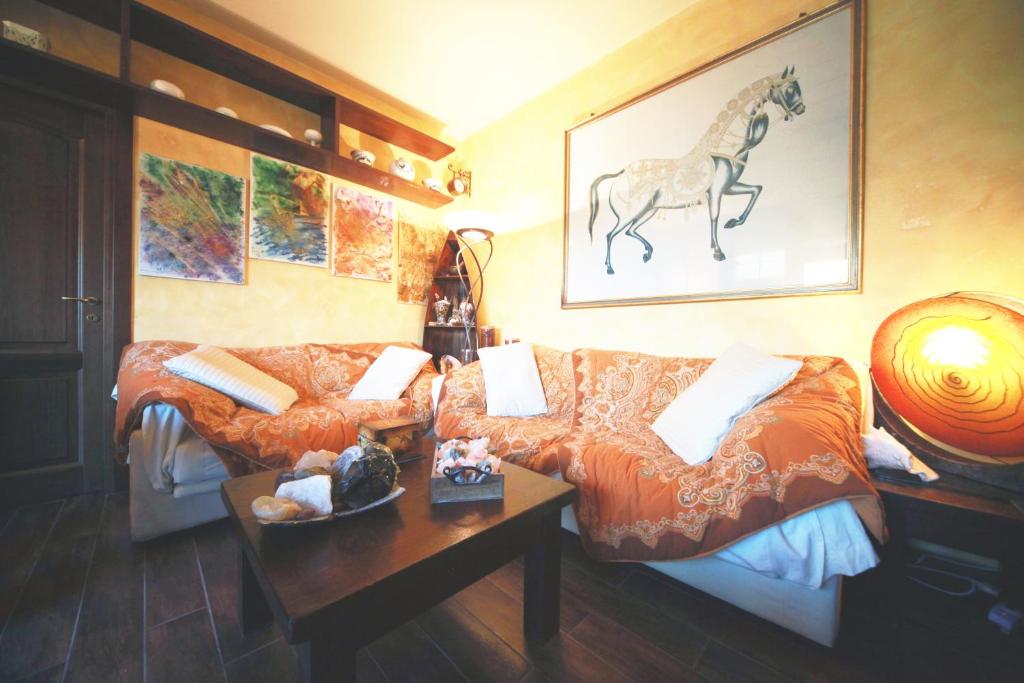 a living room with a couch and a horse on the wall at Bed & Breakfast A San Siro 75 in Milan