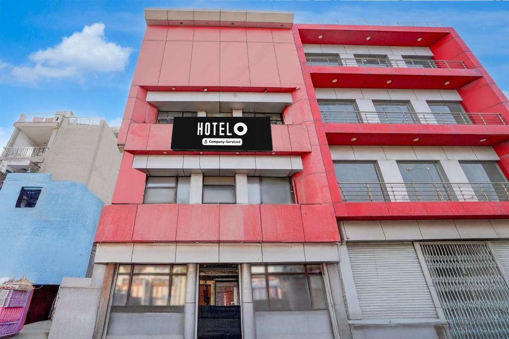 a red building with a hotel sign on it at Hotel O Charbagh Metro Station Formerly Siddhi Paradise in Lucknow