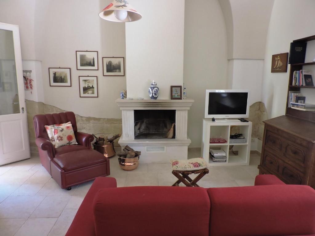 a living room with a couch and a fireplace at Villa in Salento in Lecce
