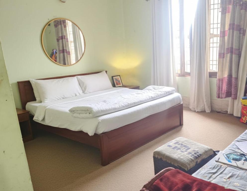a bedroom with a large bed with a mirror at Hotel Rani mahal Biratnagar in Biratnagar