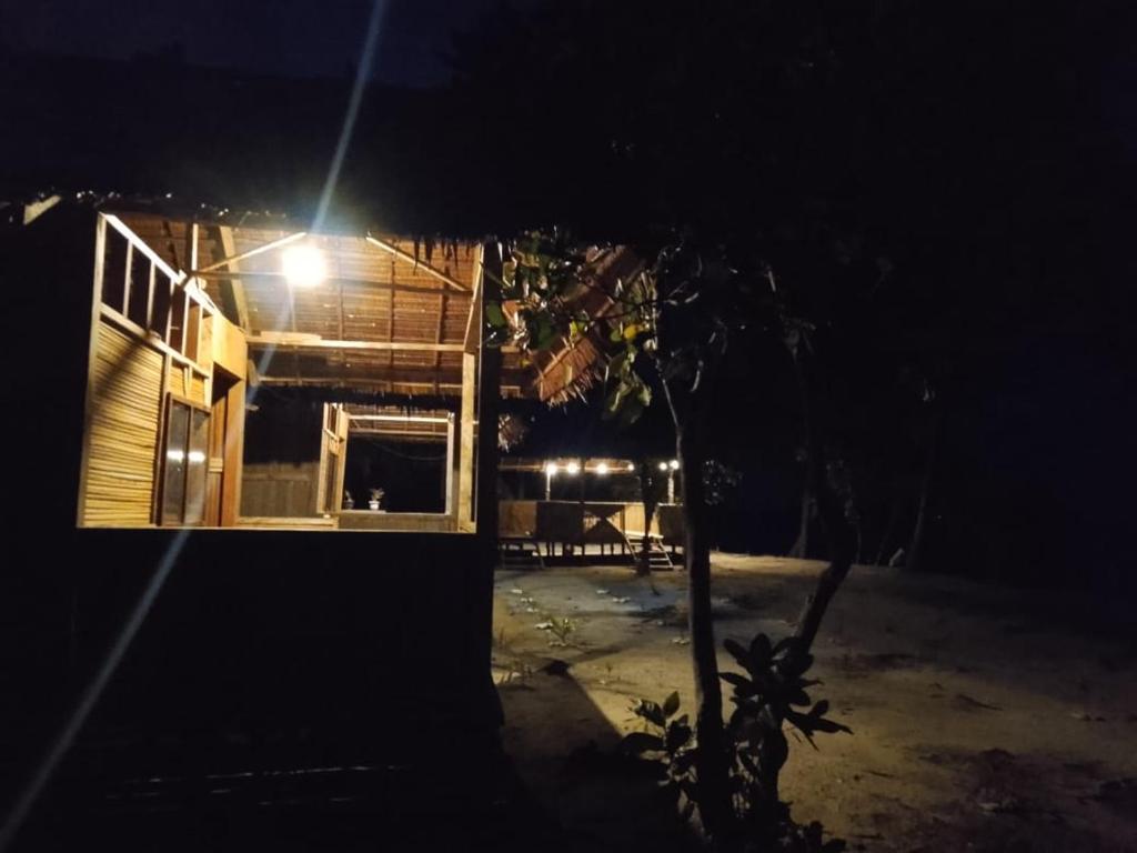 a house with a light on the side of it at night at Sawinsrom Homestay in Fam