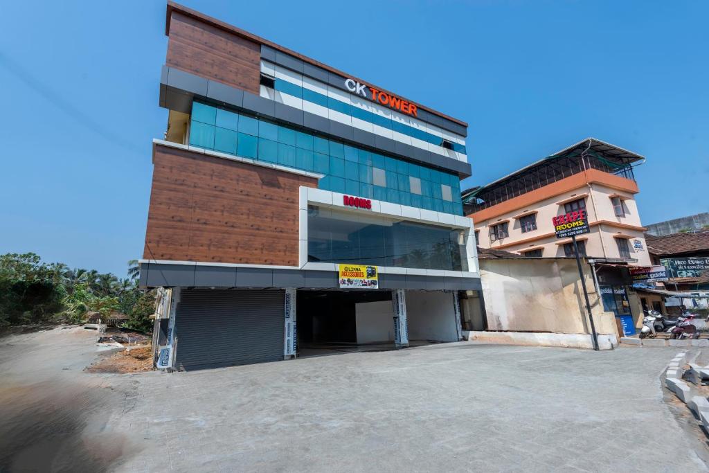 a building with a parking lot in front of it at Grape Rooms in Perintalmanna