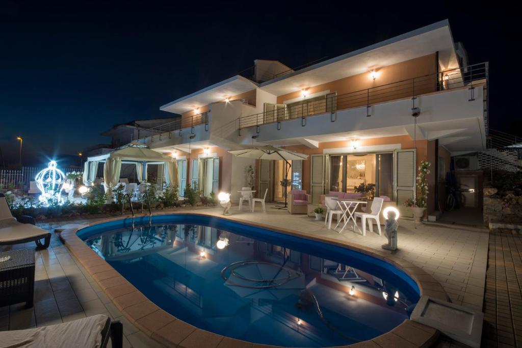 a villa with a swimming pool at night at Villa Armonia in Praia a Mare