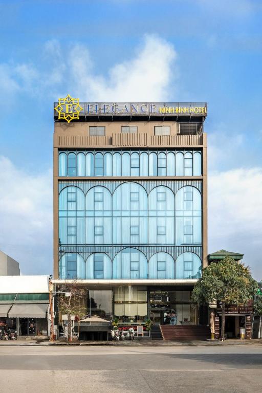 a building with a sign on top of it at Elegance Ninh Binh Hotel in Kỳ Vĩ
