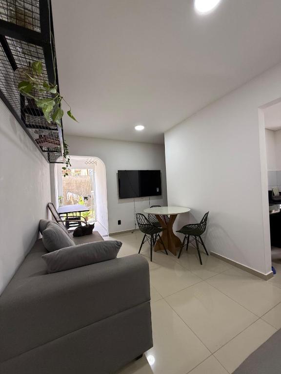 a living room with a couch and a table at AP da FLOR Guerra in Parnamirim