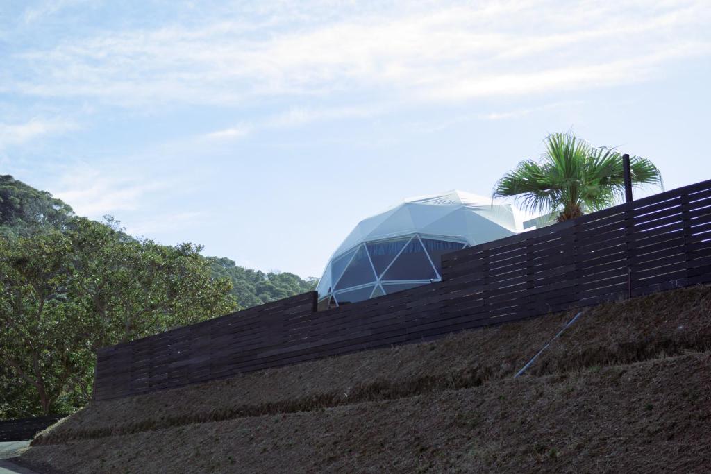 a house on top of a hill with a fence at Shinon 森音 in Tateyama