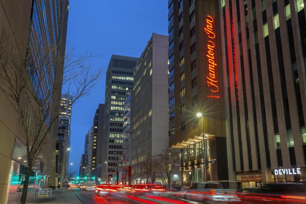 a busy city street at night with cars at Hampton Inn By Hilton Calgary Downtown in Calgary