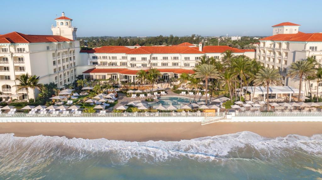 an aerial view of the beach and the resort at Eau Resort & Spa in South Palm Beach