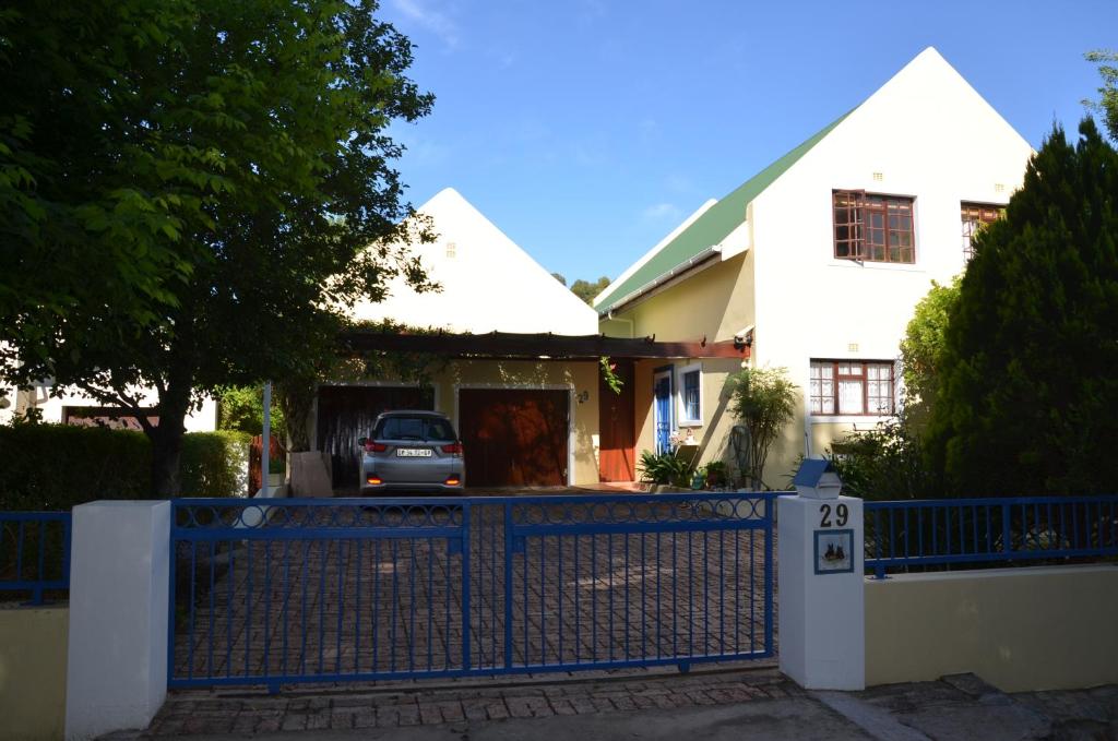 a blue fence in front of a white house at TheBlueDoor in Greyton