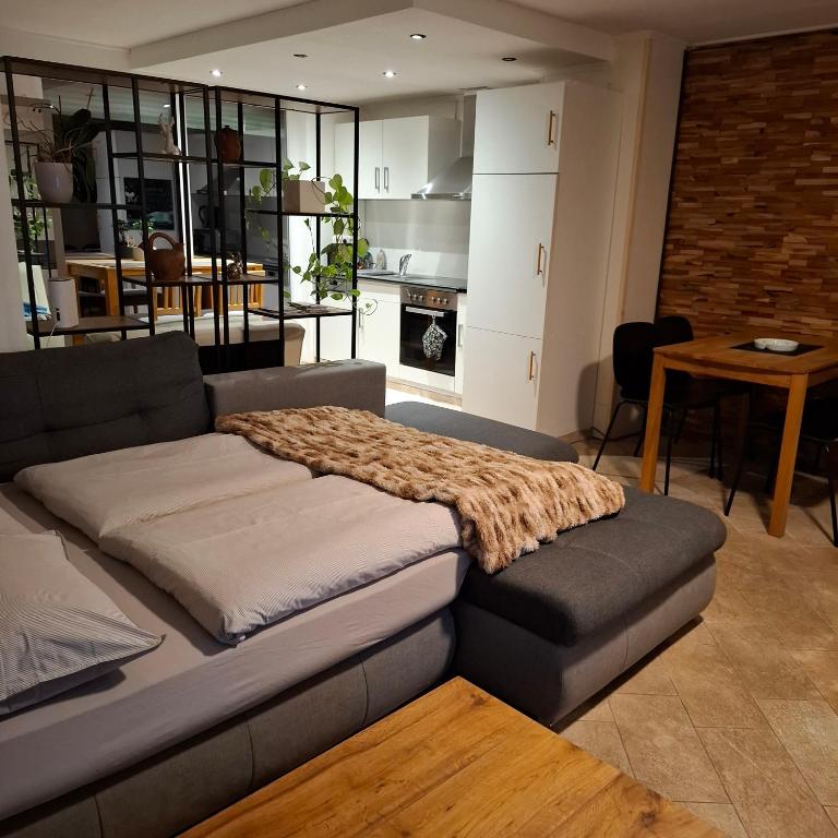 a couch with a blanket on top of it in a living room at Relax-Apartment mit Sauna in Klagenfurt