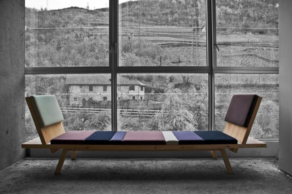 a bench in front of a window with a view at Living Kampill in Bolzano