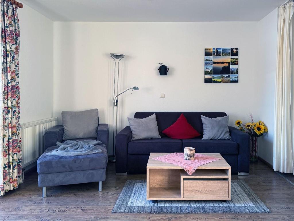 a living room with a couch and a table at Sonnenhof Seeg 12 in Seeg