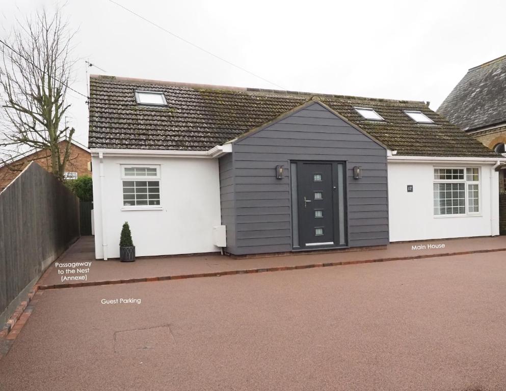 a house with a black and white garage at The Nest in Needingworth