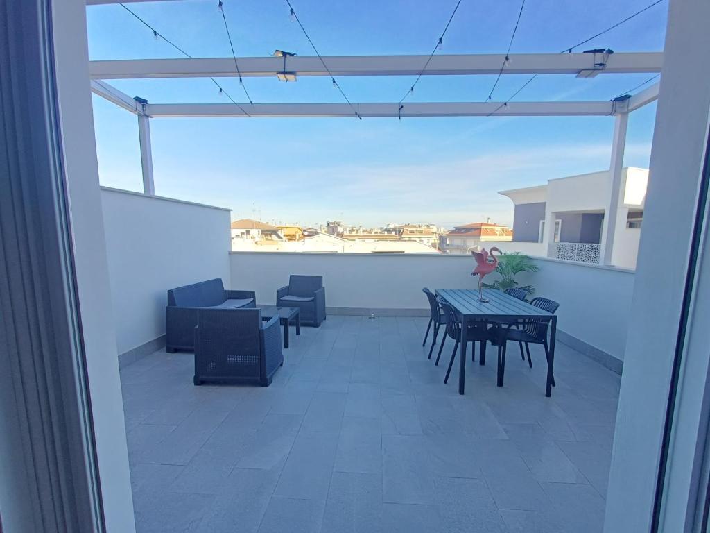 a balcony with a table and chairs and a view at Attico sulla Riserva in San Benedetto del Tronto
