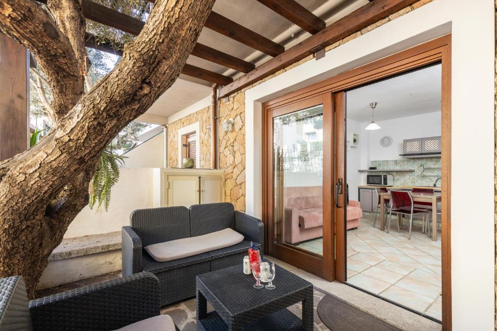 a living room with a couch and a table at Casa Ale in centro in Santa Maria Navarrese