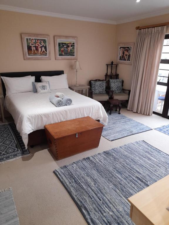 a bedroom with a large bed and a window at Barnard Self Catering Apartments in St Francis Bay