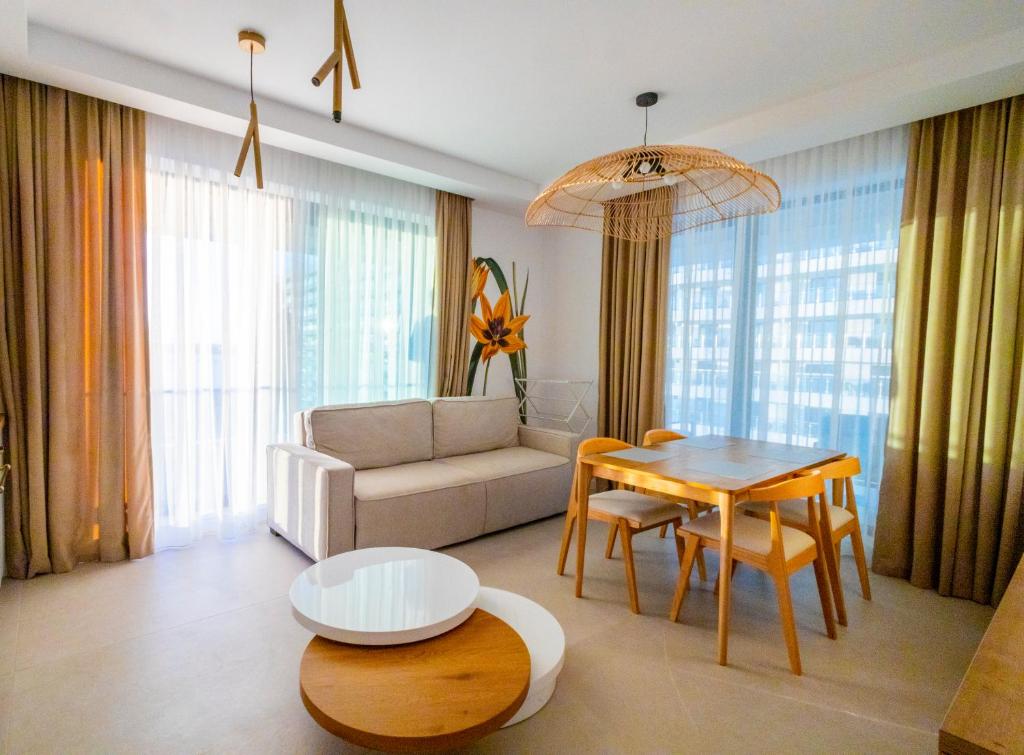 a living room with a table and a couch at Velora Apartments in Năvodari