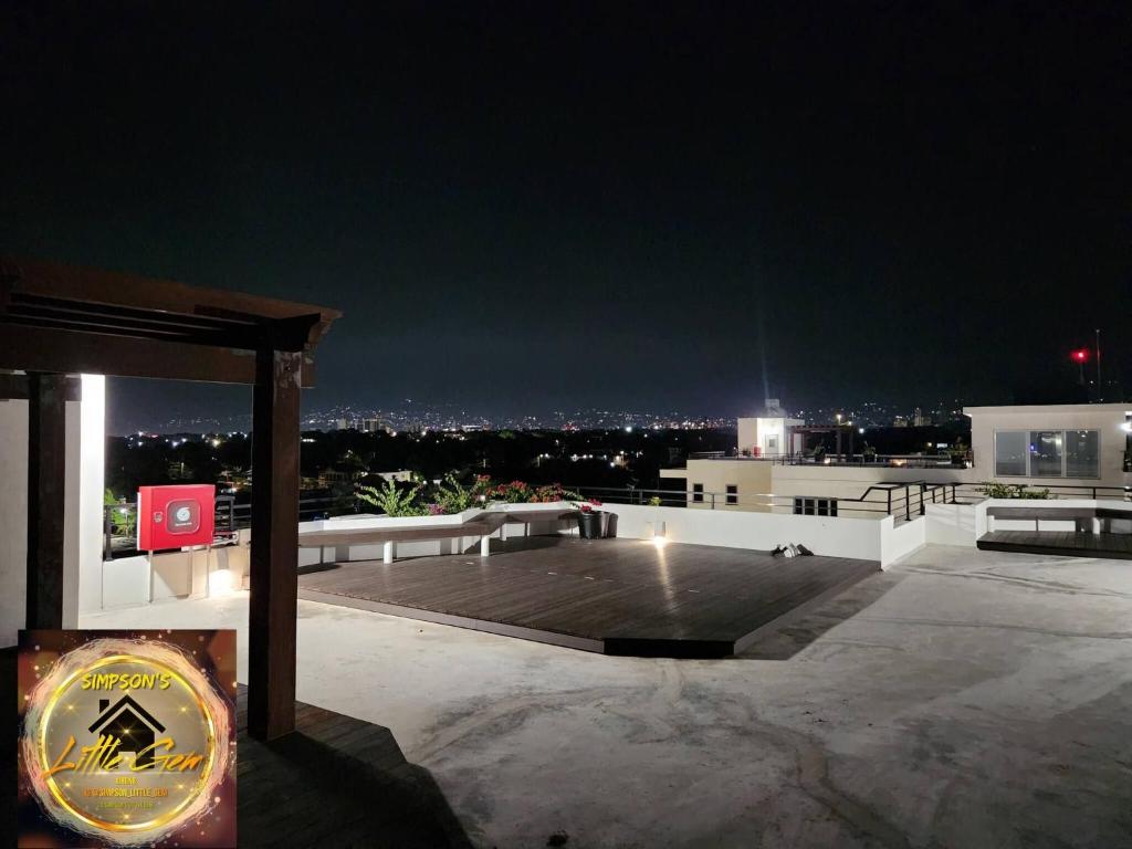 a night view of a rooftop of a building at Simpsons Little Gem 2 in Kingston
