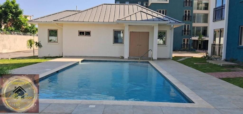 a swimming pool in front of a building at Simpsons Little Gem 1 in Kingston