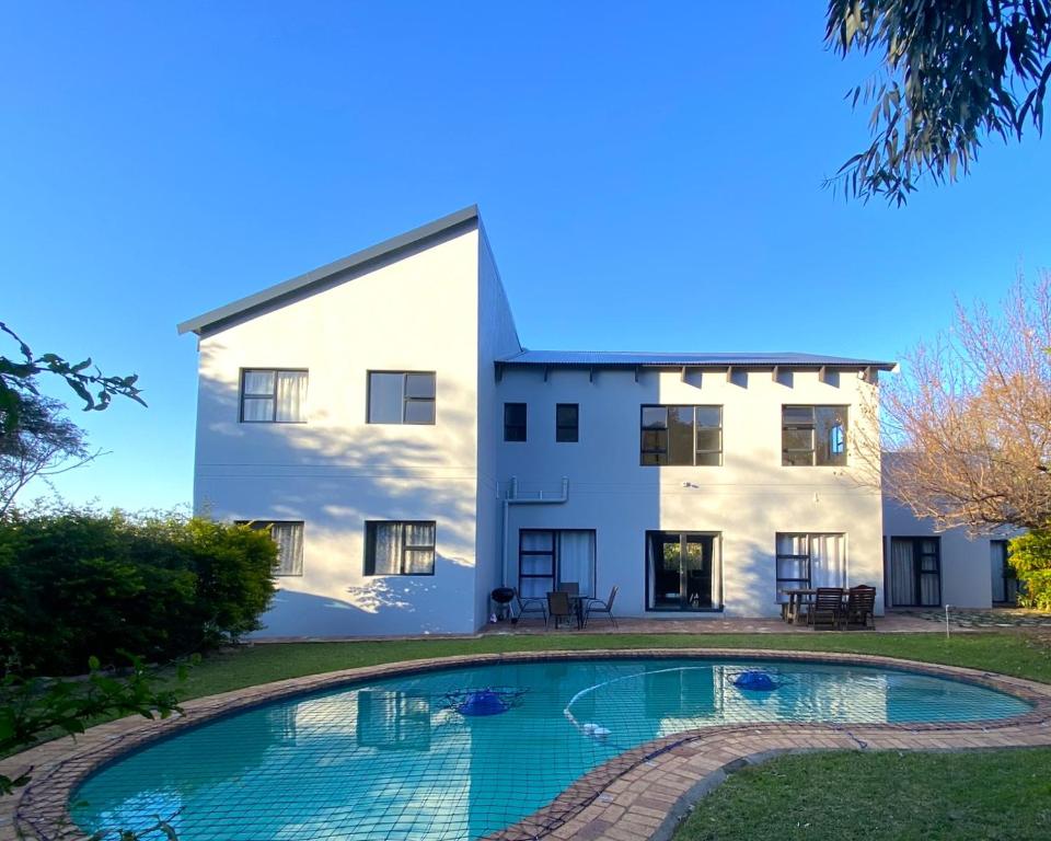 a house with a swimming pool in front of it at The Baobab in Northriding