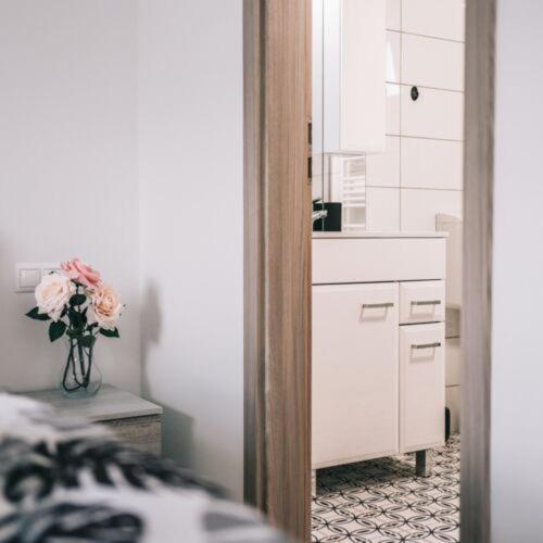 a kitchen with a vase of flowers in a room at Békeapartmanház in Badacsonytomaj