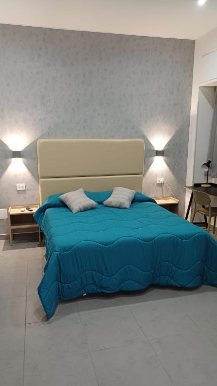 a bedroom with a blue bed with two pillows at Ai Vecchi mulini in Gragnano