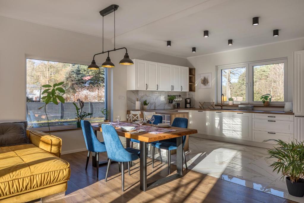 a kitchen and living room with a table and chairs at Agroturystyka Milówka in Jagodzin