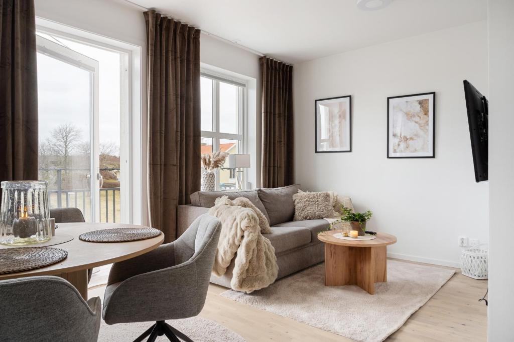 a living room with a couch and a table at Luxurious apartment in central Grebbestad! in Grebbestad