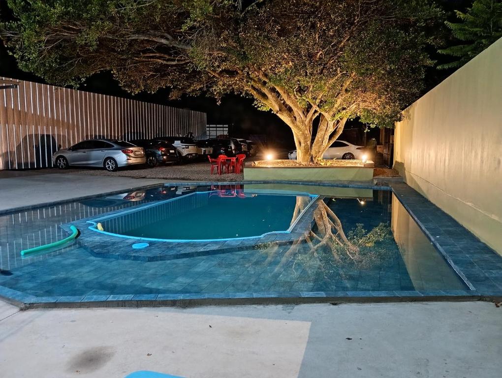 a swimming pool with a boat in a parking lot at Pousada Bella Pantano in Pântano Grande