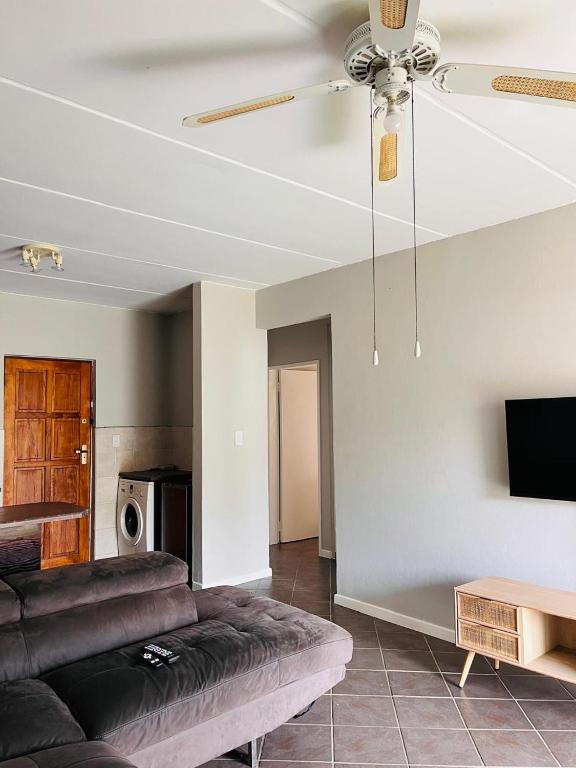 a living room with a couch and a ceiling fan at Honeypot Ridge 29 in Honeydew