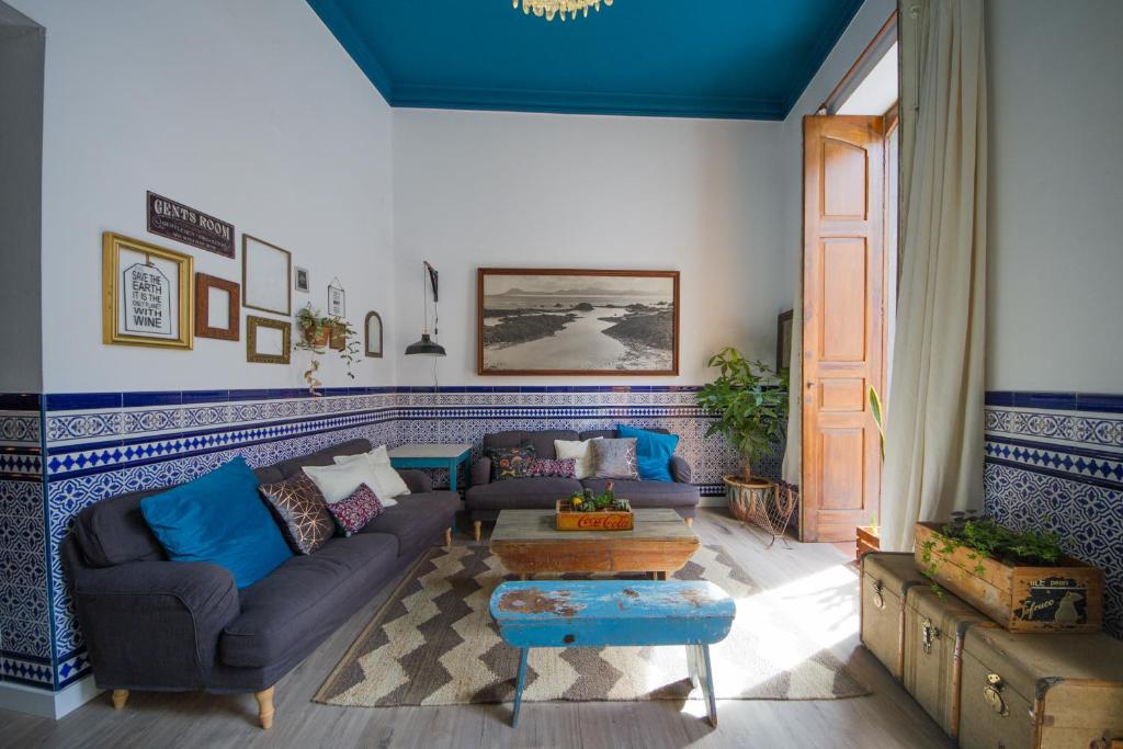 a living room with a couch and a table at Aminta Home in Las Palmas de Gran Canaria