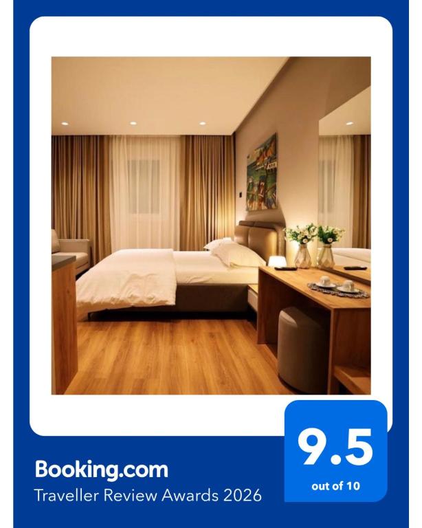 a hotel room with a bed and a desk at Theatro Hotel Apartaments Tirana in Tirana