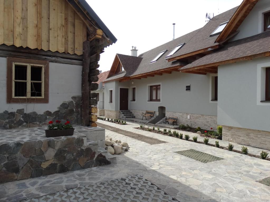 a courtyard of a house with two buildings at Drevenica Matilda in Pribylina