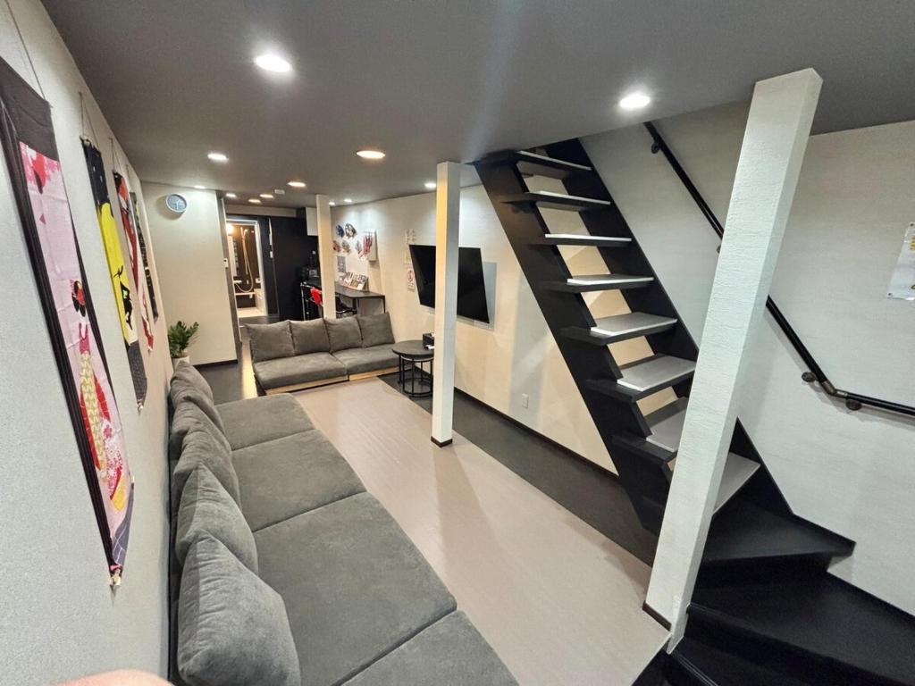a living room with a spiral staircase in a house at HOTTOSTAYHoNMACHI in Nagoya